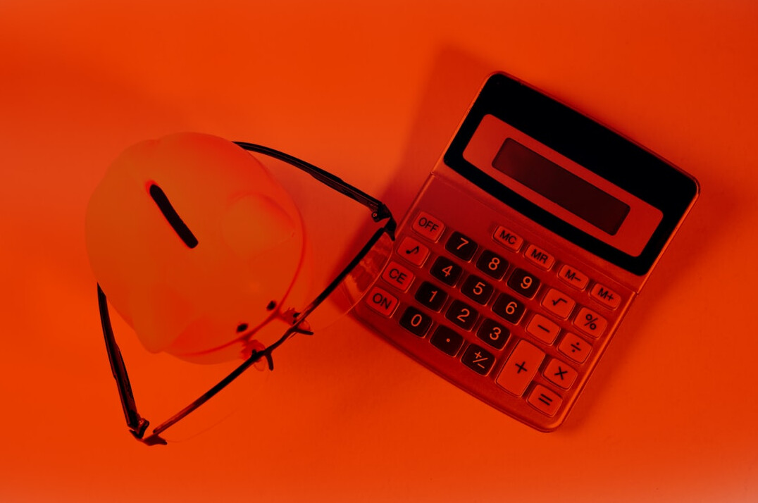 Calculator, documents and laptop on a desk for financial planning